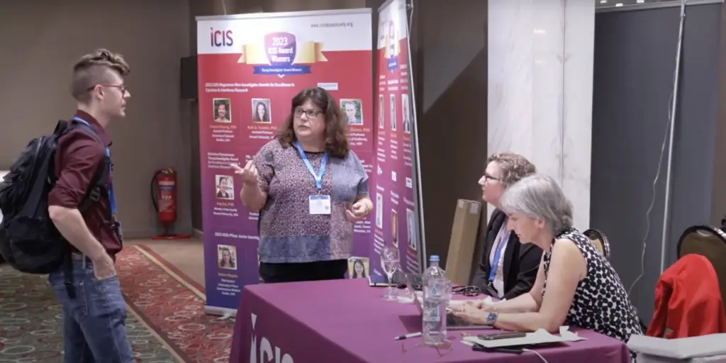 Joan Oefner (R), at the ICIS tabletop at Cytokines 2023 in Athens assisting our Pfizer and Lilly representatives.